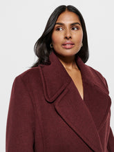 Load image into Gallery viewer, Woman wearing a burgundy coat against a plain background
